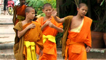 Little Buddhist monks on a street at Luang Prabang