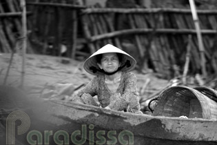A lady on a rowing boat on the Mekong River