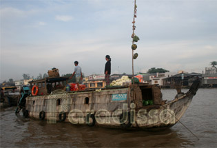 Offerings on pole on their boat in Mekong Delta
