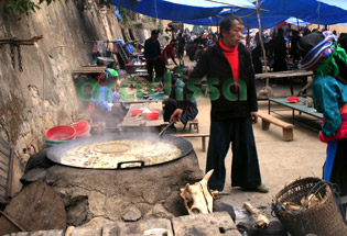 A Hmong man is cooking Thang Co
