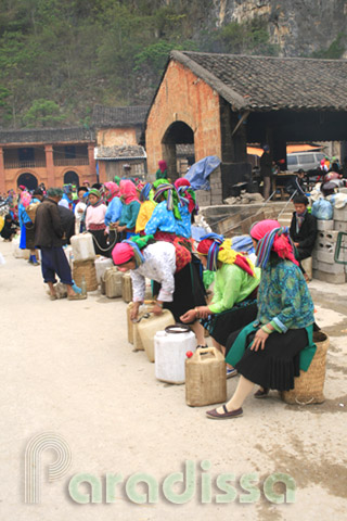 Hmong ladies selling rice wine at Dong Van Market