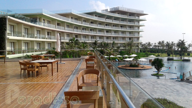 A terrace front of the resort overlooking the swimming pool and the beach