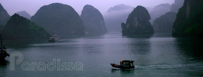 A fishing boat in the fog of magical Halong Bay