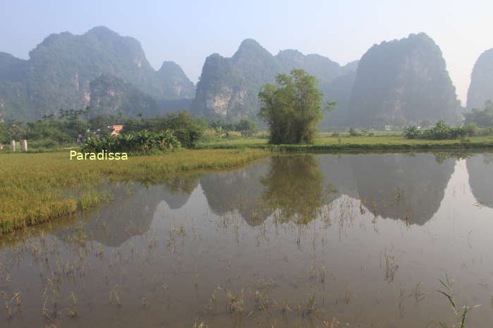 Beautiful mountain reflection in the water at Tam Coc, Ninh Binh, Vietnam