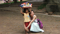 A little kid selling food near Wat Phnom in Phom Penh