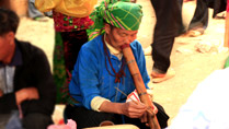 A lady smoking a pipe at Dong Van Market, Ha Giang