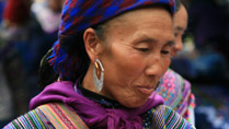 A Hmong lady at Can Cau Market smiling after a successful business day