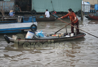 A lady sells noodle soup on a small boat at Cai Rang floating market