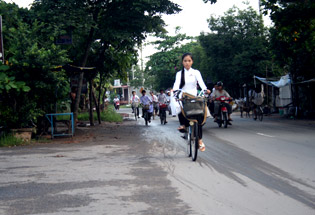 A little girl in Ao Dai at Tra Vinh Vietnam