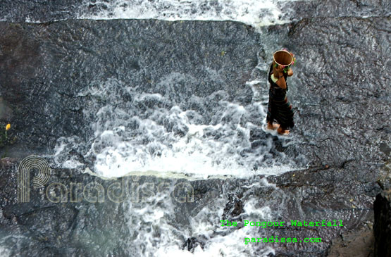 Collecting water at the Pongour Waterfall