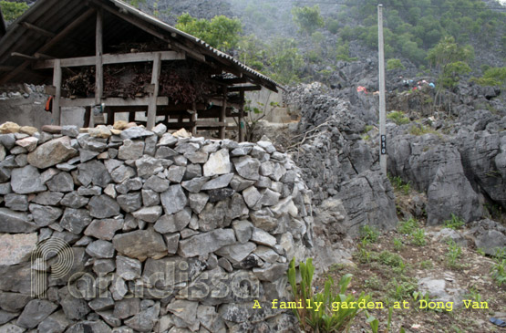 A family with a wall of rock in Dong Van