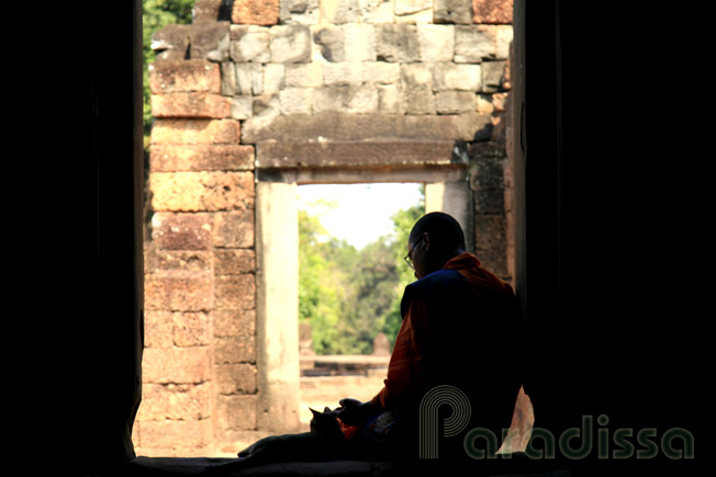 A Buddhist monk with a ktten at Bayteay Samre, Siem Reap, Cambodia