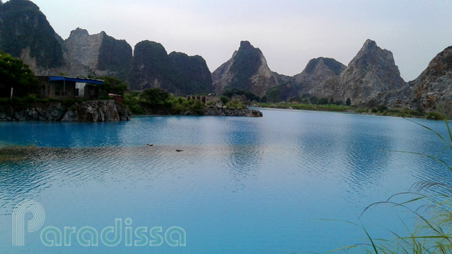 Unreal karstic mountains at turquoise water lake at Thuy Nguyen Hai Phong