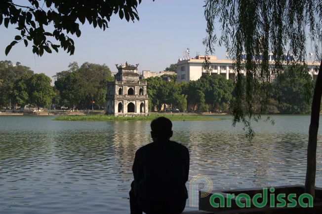 A man contemplating by the Hoan Kiem Lake in Hanoi