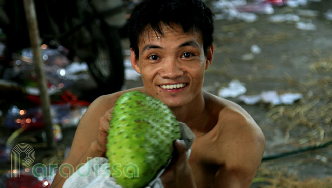 A friendly boy with a custard apple