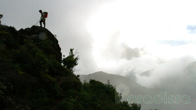 Climbing over a vertical rock cliff on the way to the summit