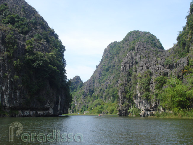 Rowing boats amid imposing karst mountains at Tam Coc, Ninh Binh