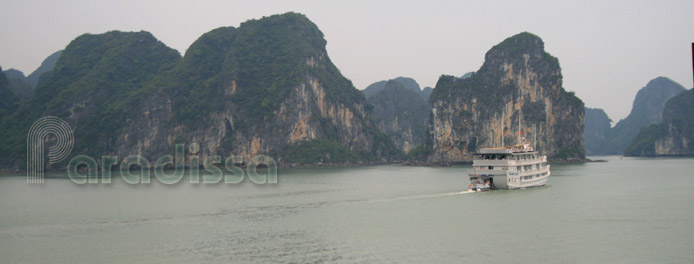 A junk cruising towards the islands on Halong Bay