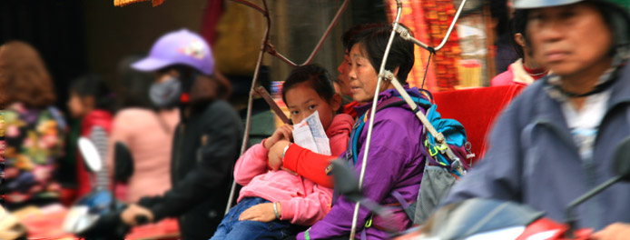 Riding a rickshaw in the Old Quarter of Hanoi