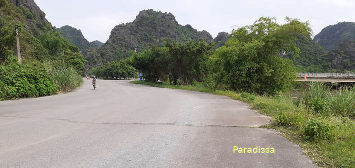 Biking amid limestone mountains in Ninh Binh Vietnam